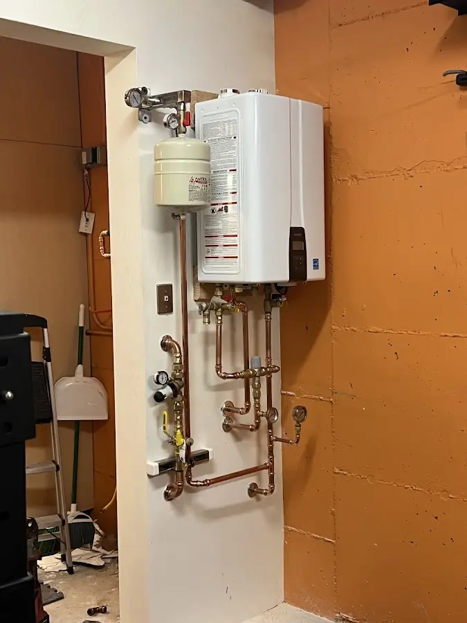 Plumbing technician inspecting water heater connections in Lake Sarasota